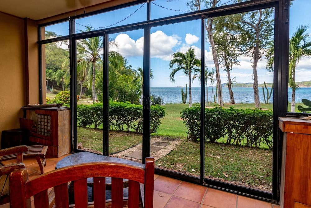 Warm Interiors and Orange Hues on Ground Floor in Front of Beach